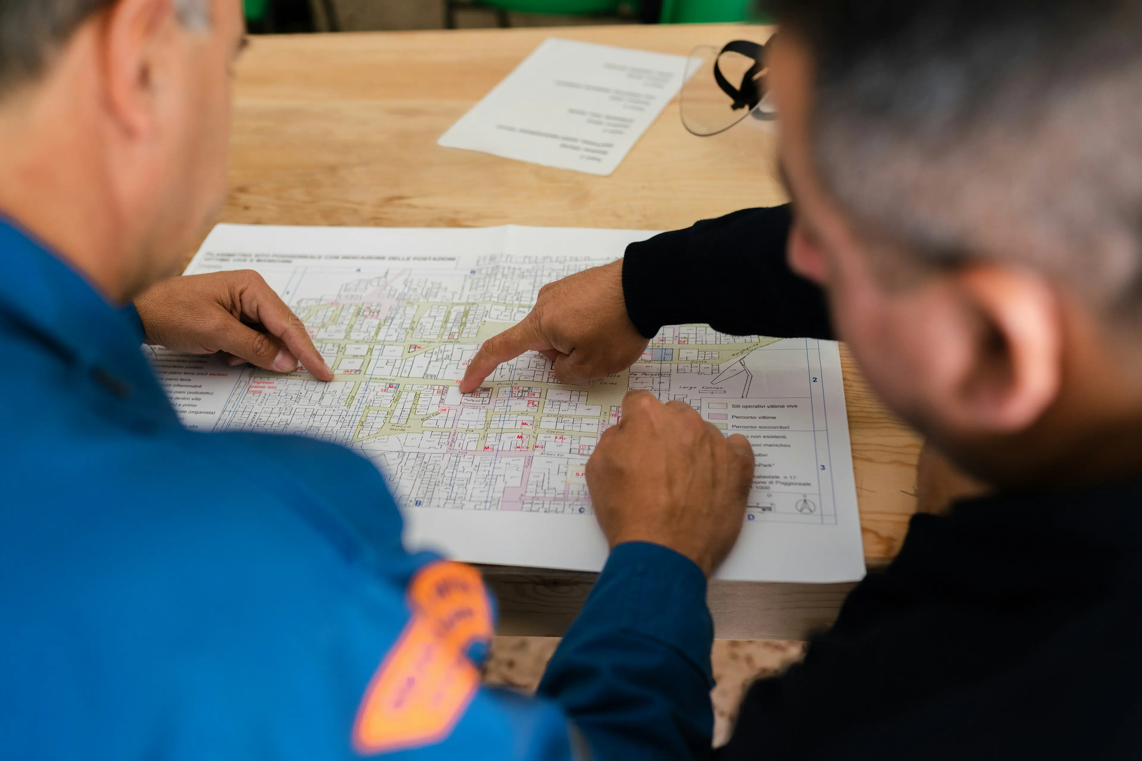 Engineers reviewing a printed solar site layout on a table