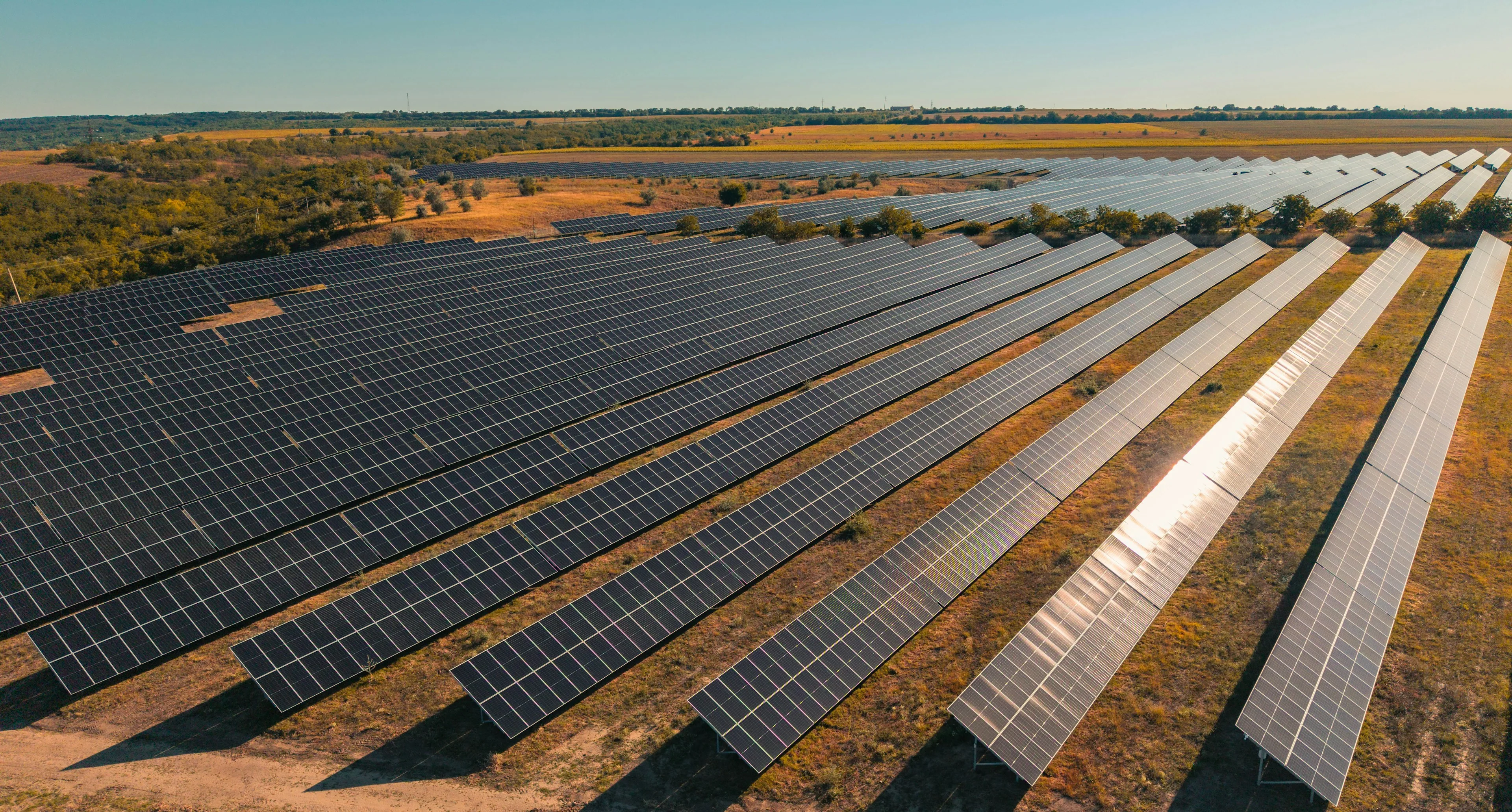 Aerial view of a large solar farm at golden hour