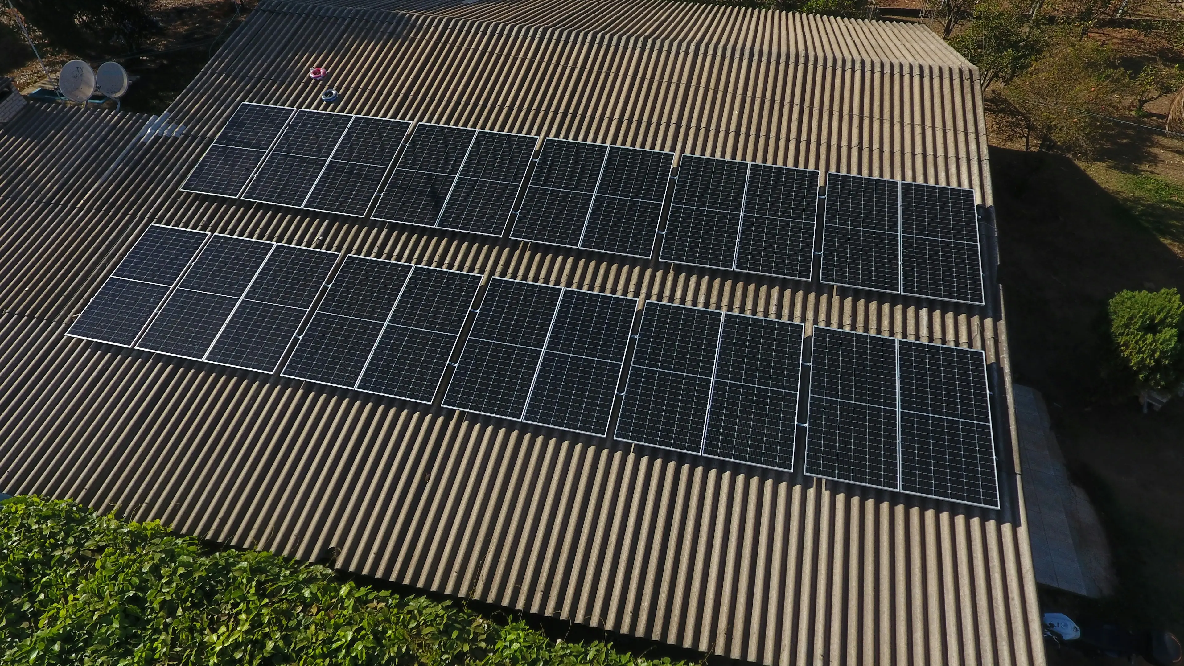 Aerial view of a large solar array on an industrial rooftop